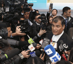 Rafael Correa speaks to the press in Beijing.