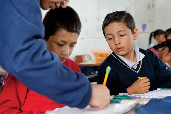 A teacher works with students in Mexico
