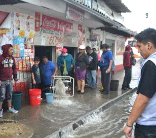 Water is pumped from an Av. Las Americas store on Saturday.