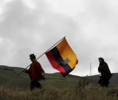 Protesters of mining project carry the flag in Intag Valley.