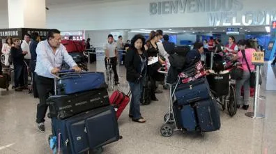 Quito airport officers say that dozens of Venezuelan families arrive each day.