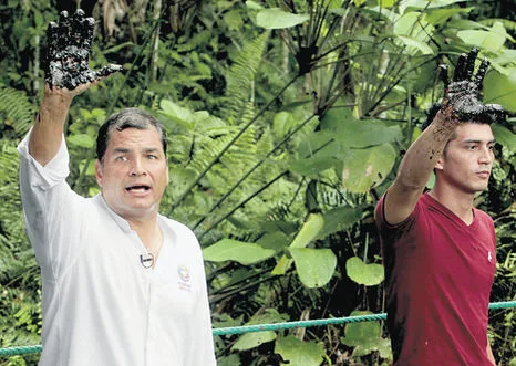 President Rafael Correa is "oily hand" media event in early 2014.