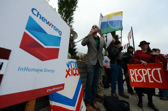 Adam Zuckerman of Amazon Watch leads the protest Wednesday against Chevron Oil in Ecuador oil pollution case. 